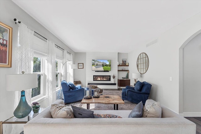 living room with a fireplace and hardwood / wood-style floors