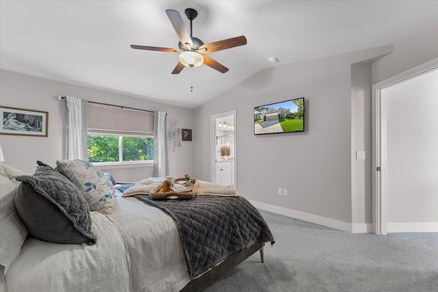 carpeted bedroom with ensuite bath, vaulted ceiling, and ceiling fan