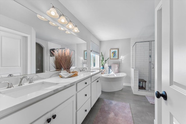 bathroom with vanity and independent shower and bath