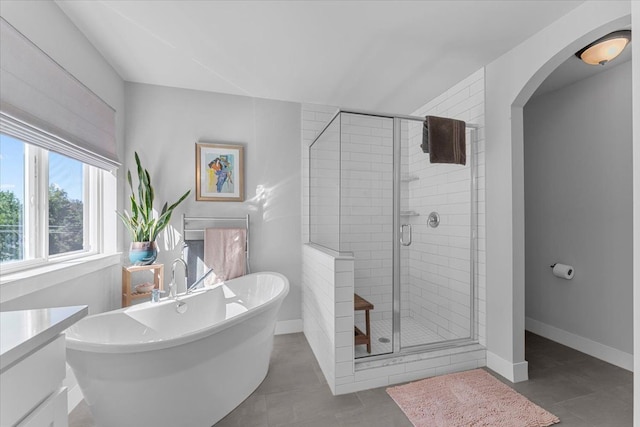 bathroom with tile patterned floors, vanity, and separate shower and tub