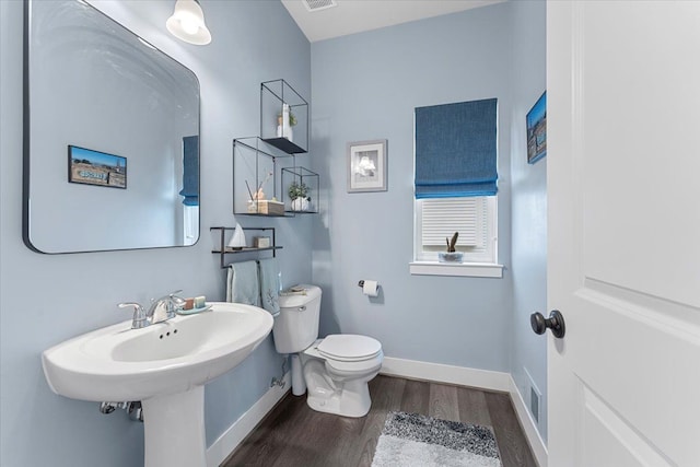 bathroom with toilet and hardwood / wood-style flooring