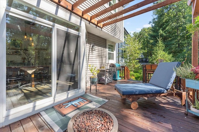 wooden terrace featuring a pergola and area for grilling