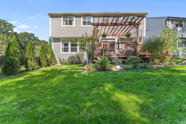 rear view of property with a pergola, a yard, and a wooden deck