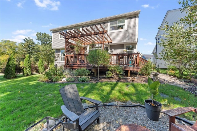 rear view of house featuring a pergola, a wooden deck, and a yard