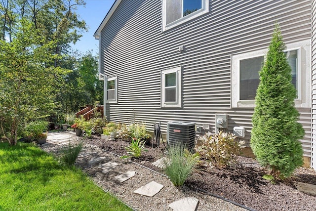 view of side of home with central AC unit