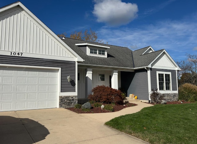 craftsman-style house featuring a garage and a front yard