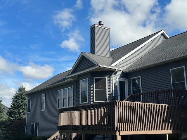 rear view of house featuring a wooden deck