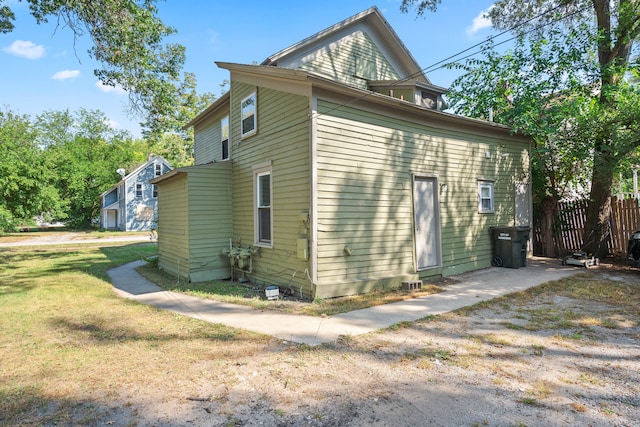 view of side of home with a lawn