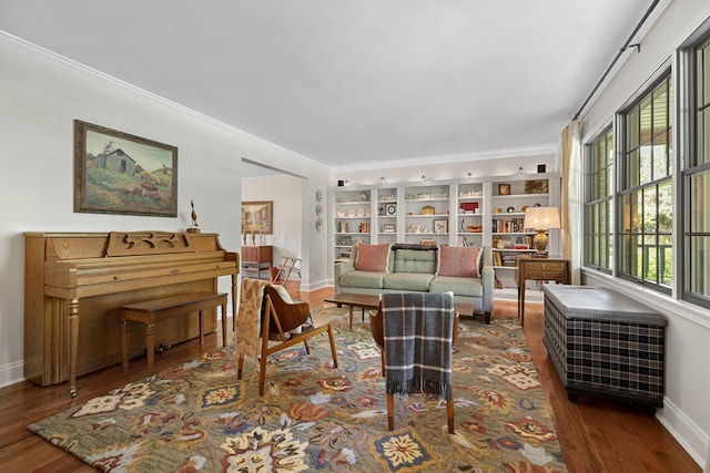 sitting room with dark wood-type flooring and ornamental molding