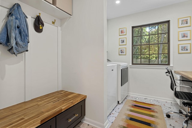 laundry area featuring washer and dryer and cabinets