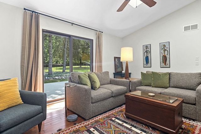 living room featuring ceiling fan, wood-type flooring, and lofted ceiling