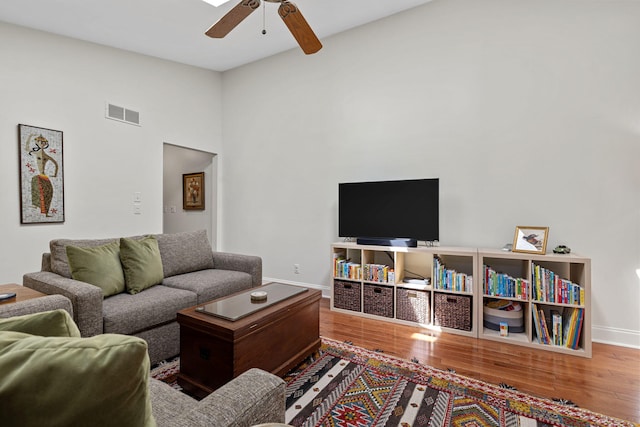 living room with hardwood / wood-style flooring and ceiling fan