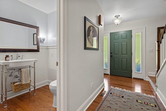 entryway with wood-type flooring and sink