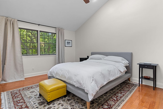 bedroom featuring hardwood / wood-style floors, ceiling fan, and lofted ceiling