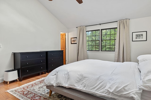 bedroom with light wood-type flooring, ceiling fan, and lofted ceiling