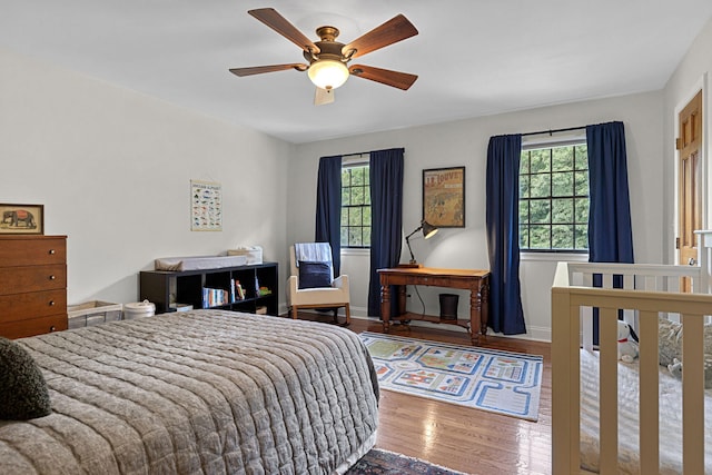 bedroom with ceiling fan and wood-type flooring