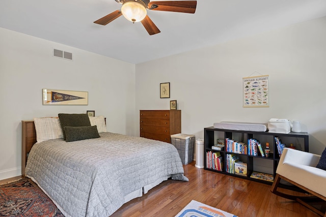 bedroom with hardwood / wood-style floors and ceiling fan