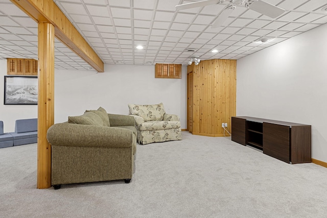 living room featuring wood walls and carpet floors