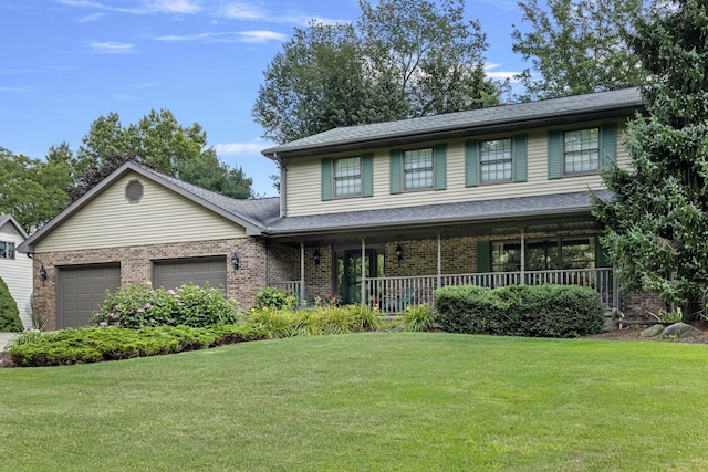 view of front of property with a front lawn, a porch, and a garage