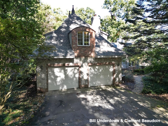 view of side of home with a garage