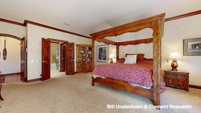 bedroom featuring ensuite bath, ornamental molding, and light carpet