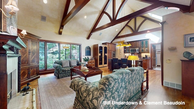 living room featuring high vaulted ceiling and beamed ceiling