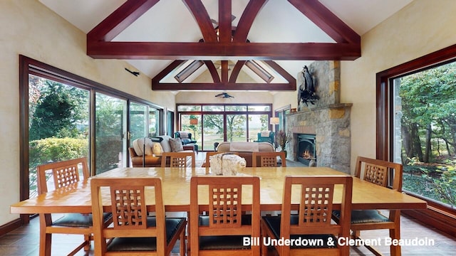 dining area with beam ceiling and high vaulted ceiling