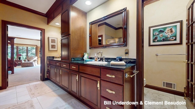 bathroom featuring vanity, crown molding, and toilet