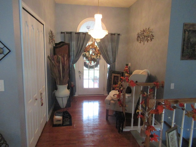 interior space with wood-type flooring and an inviting chandelier