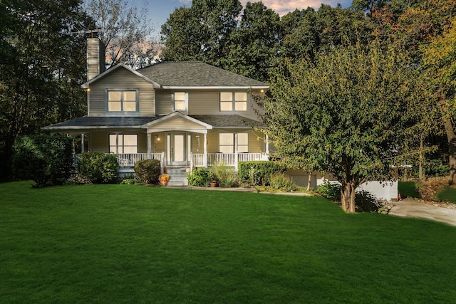 view of front facade featuring french doors, a porch, and a yard