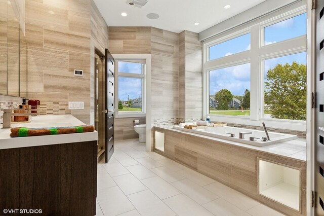 10 Peninsula Dr, New Buffalo, MI 49117 - bathroom with tile walls, toilet, healthy amount of natural light, vanity, and a bath