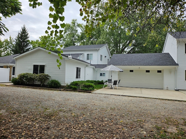 view of front of home with a patio area and a garage