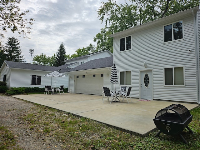 rear view of house featuring a garage