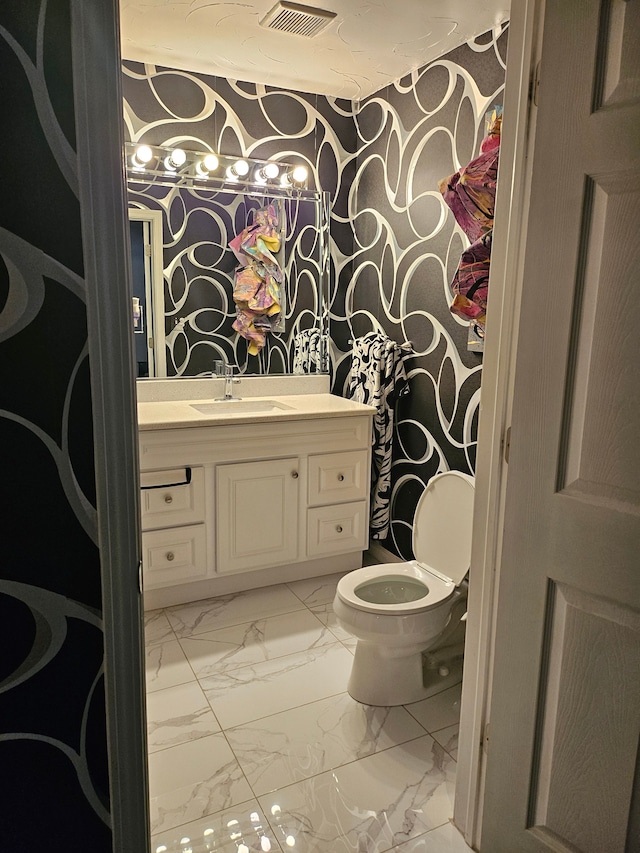 bathroom with vanity and toilet