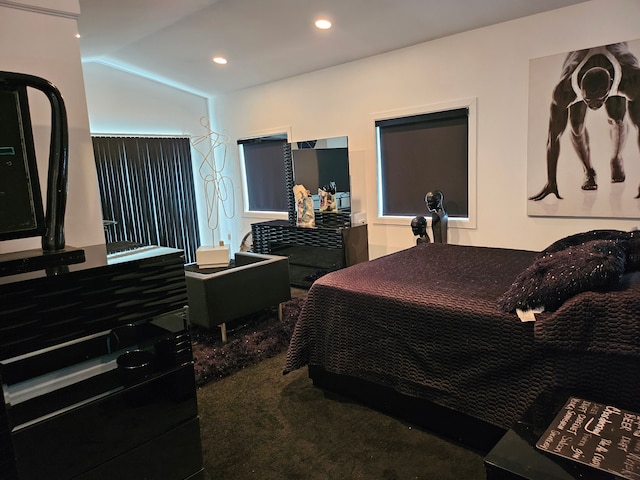 bedroom with carpet floors and vaulted ceiling