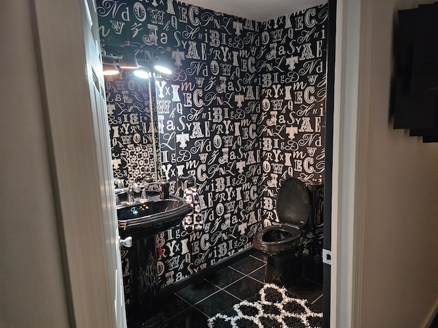 bathroom featuring tile patterned flooring and toilet