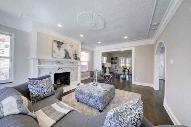 17566 Monica St, Detroit, MI 48221 - living area with arched walkways, wood finished floors, a textured ceiling, ornamental molding, and baseboards