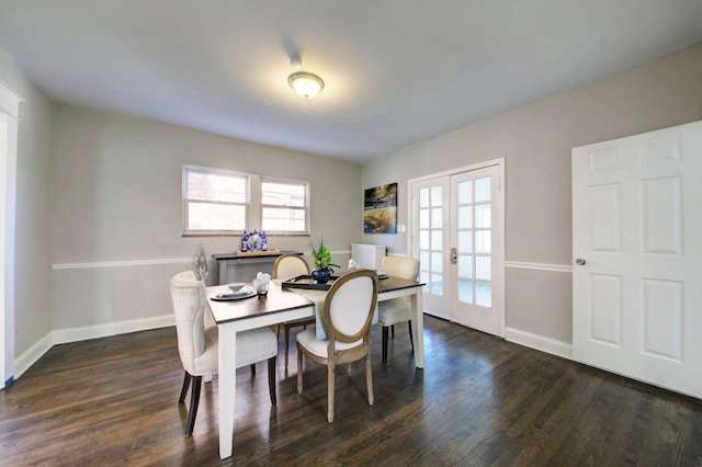 dining room with dark hardwood / wood-style floors and french doors