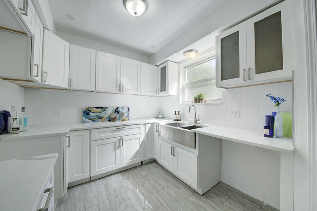 17566 Monica St, Detroit, MI 48221 - kitchen with light stone countertops, backsplash, and white cabinets