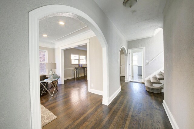 17566 Monica St, Detroit, MI 48221 - foyer with arched walkways, dark wood-style flooring, baseboards, stairway, and a textured ceiling