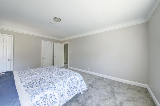 bedroom featuring crown molding and carpet