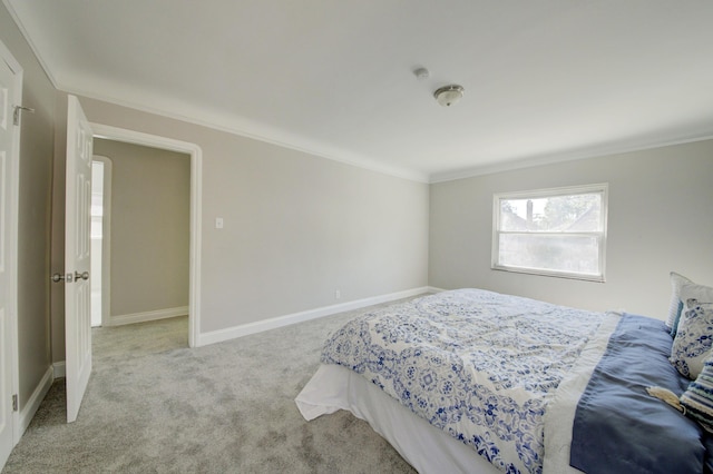 bedroom with crown molding and light carpet