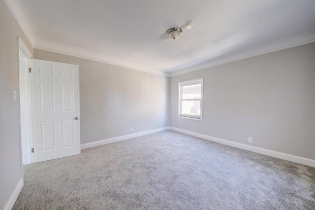 carpeted spare room featuring ornamental molding