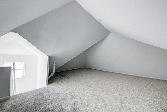 bonus room featuring lofted ceiling and carpet floors