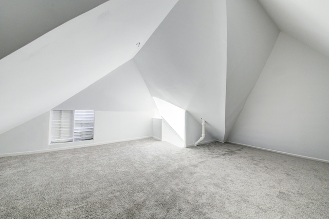 bonus room with lofted ceiling and carpet floors