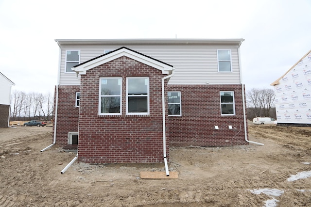 rear view of house featuring brick siding