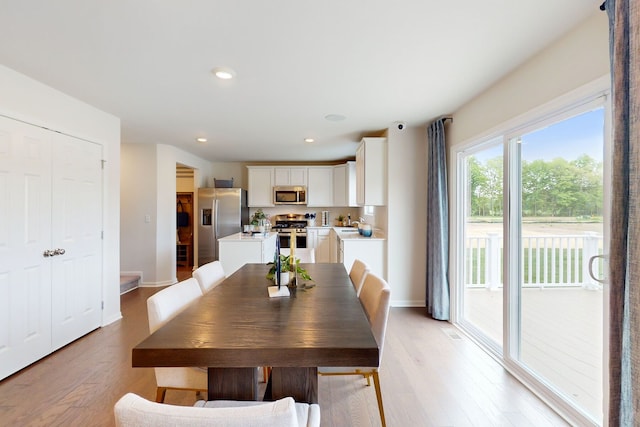 dining room featuring visible vents, recessed lighting, light wood-style floors, and baseboards