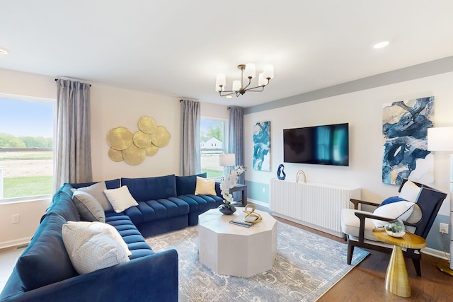 living area featuring recessed lighting, light wood-style flooring, baseboards, and an inviting chandelier