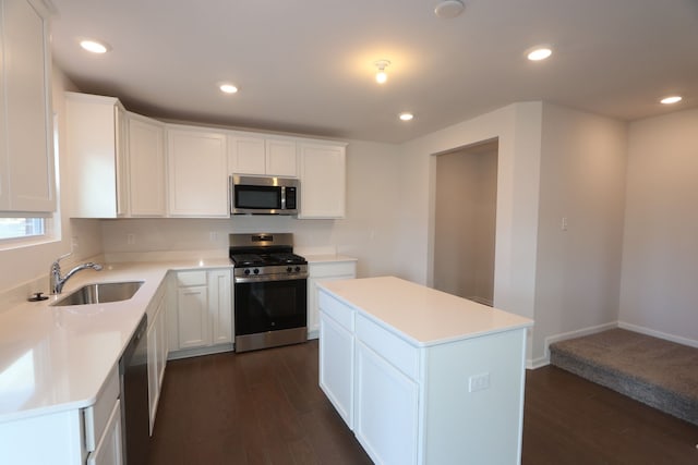 kitchen with recessed lighting, dark wood-style flooring, a sink, light countertops, and appliances with stainless steel finishes