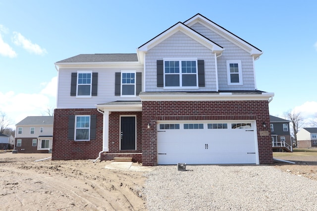 view of front facade featuring a garage, brick siding, and driveway